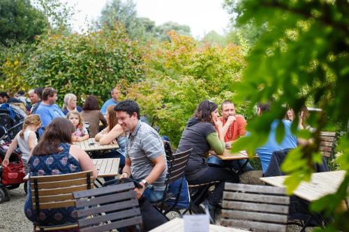 a group of people sitting at tables in a park at The Mooring Post in Gloucester