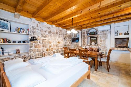 a bedroom with two beds and a dining room with a table at Studio Apartment Pupa in Dubrovnik