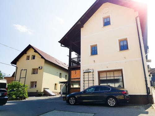 a black car parked in front of a building at Fado Apartments Gornja Radgona in Gornja Radgona