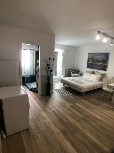 a living room with a bed and a couch at LX Lisboa Cozy studio in Lisbon
