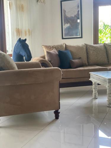 a living room with a couch and a table at Villa Crystals in Colombo