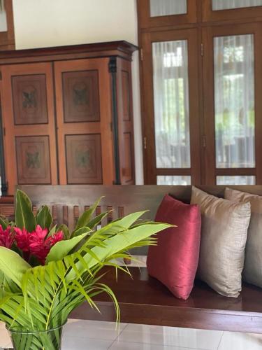 a couch with several pillows on top of it at Villa Crystals in Colombo