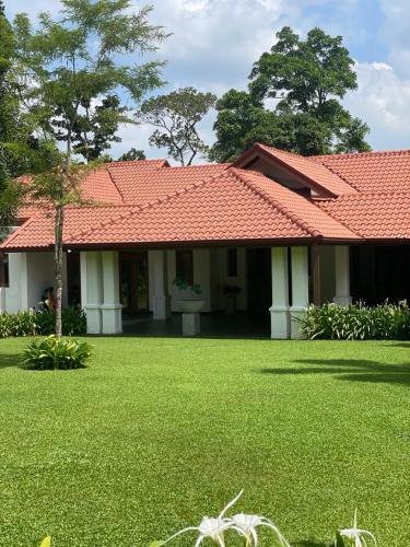 a house with an orange roof and a yard at Villa Crystals in Colombo