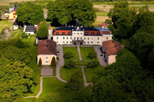 an aerial view of a large white house with red roofs at Södertuna Slott in Gnesta