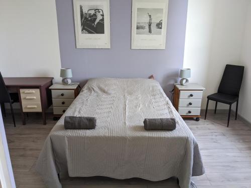 a bedroom with a bed and a desk and a chair at Les Gîtes de Brives in Brives-sur-Charente