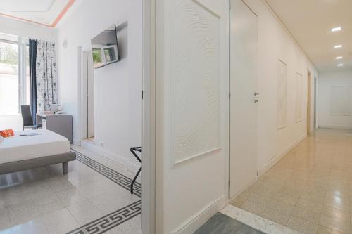 a room with a hallway with white walls and a door at Erreggi Luxury Rooms in Rome