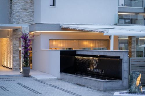 a building with a fireplace in front of it at Panorama Hill Hotel in Iraklitsa