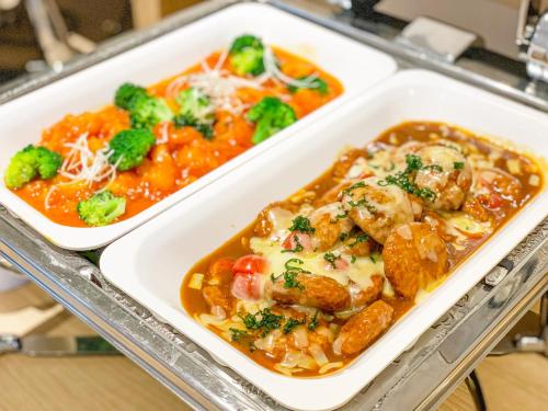 two styrofoam trays of food on a table at LiVEMAX RESORT Atami Sea Front in Atami
