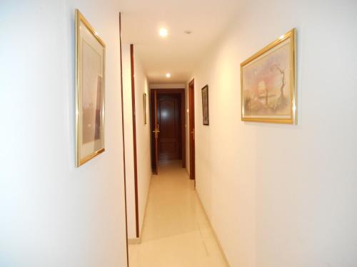 a hallway with paintings on the walls of a house at Martin House & Granada in Granada