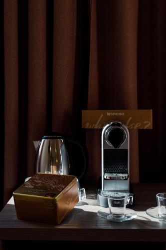 a coffee maker and a box on a table at Erreggi Luxury Rooms in Rome