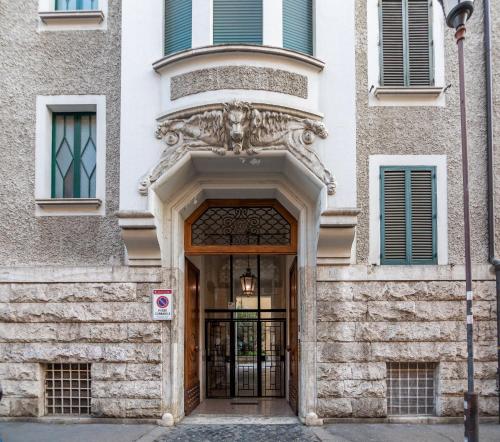 an entrance to a building with a door with a statue at Erreggi Luxury Rooms in Rome