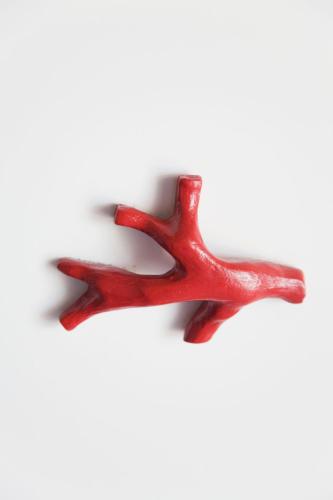 a pair of red metal antlers on a white background at Hotel La Terrazza in Panarea
