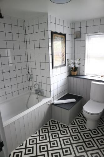 a bathroom with a tub and a toilet at 12 Ivy Cottage in St Ives