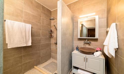 a bathroom with a sink and a mirror at Villa Barozziana Private Heated Pool & Jacuzzi in Rethymno Town