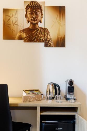 a statue on a desk with a table with a table at Erreggi Luxury Rooms in Rome