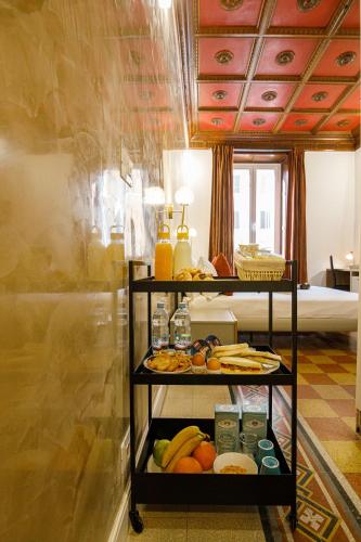 a shelf with fruit and drinks on it in a room at Erreggi Luxury Rooms in Rome