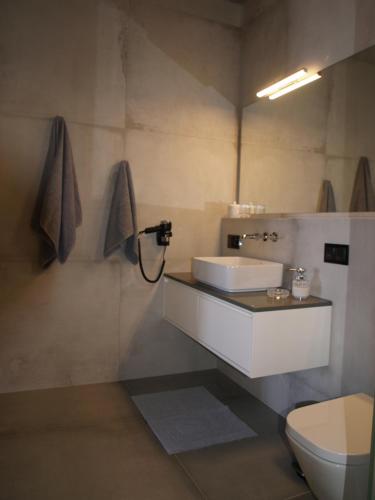 a bathroom with a sink and a toilet at MIROS MARE STUDIOS in Agia Galini