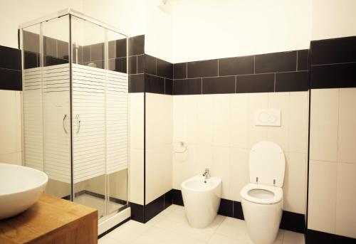 a bathroom with a toilet and a sink at HOTEL CAMPO STELLA in Leonessa