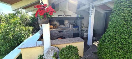 a outdoor kitchen with a stove in a house at Apartments Villa Krasa in Lovran
