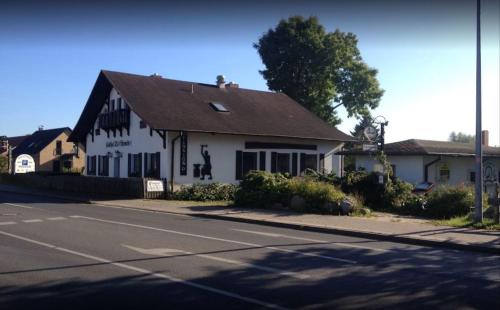 a white building on the side of a street at Pension Alte Schmiede in Greifswald