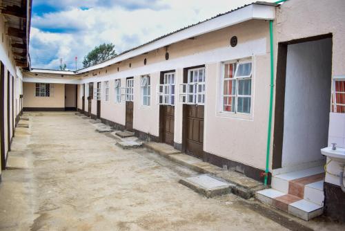 a long row of buildings with doors and windows at Luna Light Guest House in Naivasha