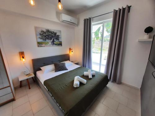 a bedroom with a bed with two towels on it at Elia Boutique Studios in Kalithies