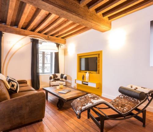 a living room with a couch and a table at Dijon La Belle Adresse in Dijon