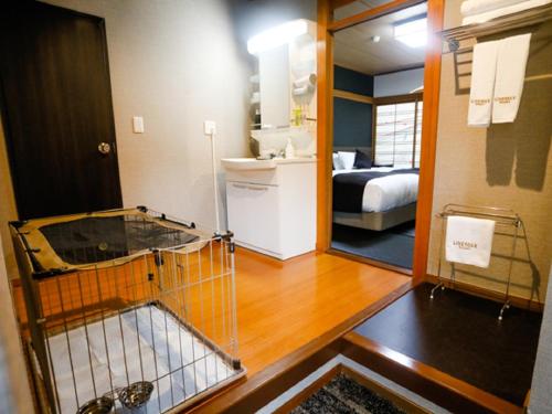 a room with a room with a bed and a mirror at LiVEMAX RESORT Okudogo in Matsuyama