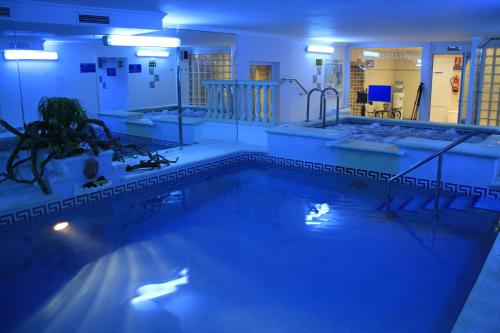 a large swimming pool with two sinks and a tub at Hotel & Spa Entremares in La Manga del Mar Menor