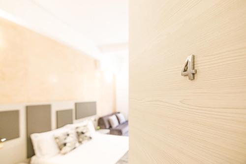 a room with two beds and a door with a number four at Erreggi Luxury Rooms in Rome