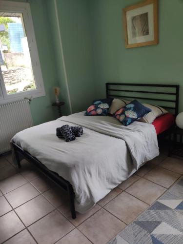 a person laying on a bed in a bedroom at B&B En plein coeur de la forêt in Artiguelouve
