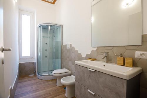 a bathroom with a toilet and a sink and a shower at Erreggi Luxury Rooms in Rome