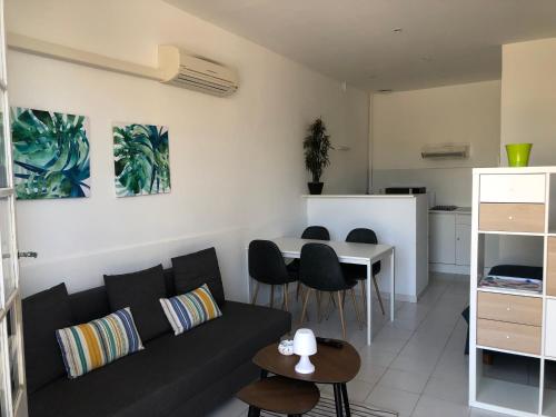 un salon avec un canapé et une table dans l'établissement Étoile de la plage Parking privé gratuit, à La Ciotat