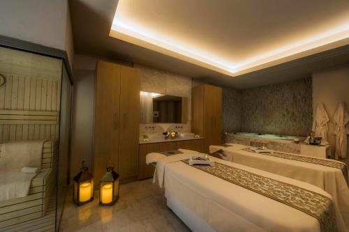a hotel room with four beds and a bathroom at Le Blanc Spa Resort Los Cabos Adults Only All-Inclusive in San José del Cabo