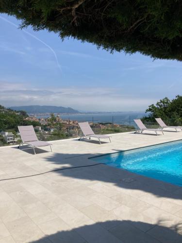 a group of chairs sitting next to a swimming pool at Villa Lilia in Vietri sul Mare