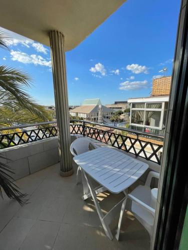 una mesa y sillas en el balcón de una casa en Vivienda Turística Playa Vida Punta Umbría, en Punta Umbría