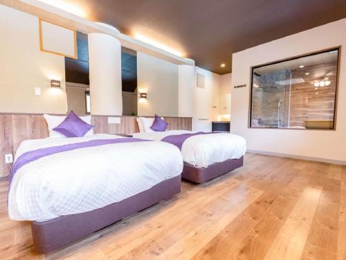 Postel nebo postele na pokoji v ubytování LiVEMAX RESORT Kusatsu Onsen
