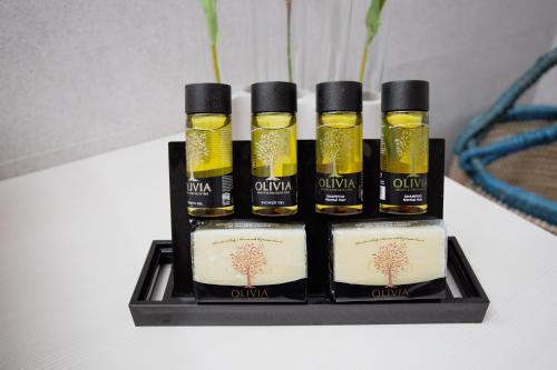 a group of four bottles of oil on a shelf at Akti Taygetos - Conference Resort in Kalamata