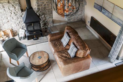 a living room with a couch and a fireplace at The Blind Bull in Little Hucklow