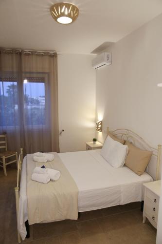 a bedroom with a bed with towels on it at I 7 Peccati in Marina di Mancaversa