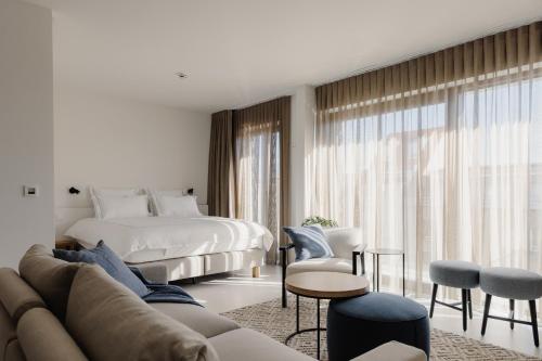 a living room with a bed and a couch at Portwin luxury stays in Knokke-Heist