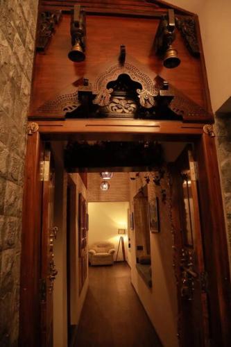 a hallway leading to a room with a clock on the wall at Anandam Stays - Premium 3BHK plush homestay, Vaikom near Kumarakom in Vaikom