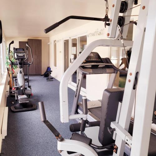 a gym with tread machines and a treadmill at Hotel et Motel Le Chateauguay in Quebec City