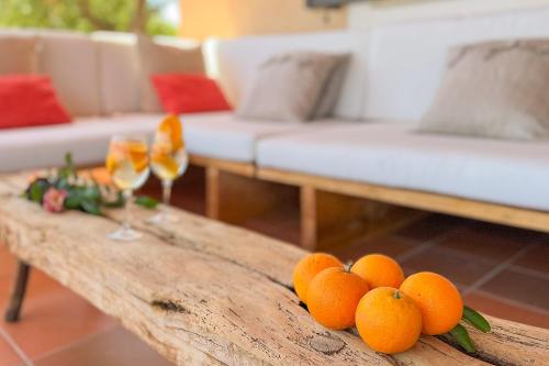 a bunch of oranges on a wooden table in a living room at Villa Sa Tanca in Campos