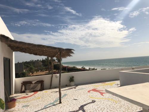 a balcony with a view of the ocean at Bine Bassile in Guéréo