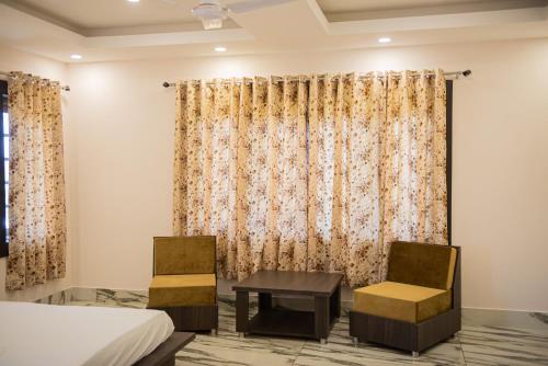 a bedroom with a bed and a table and chairs at SETHI's HOMESTAY in Srinagar