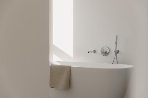 a bathroom with a white tub and a sink at Portwin luxury stays in Knokke-Heist
