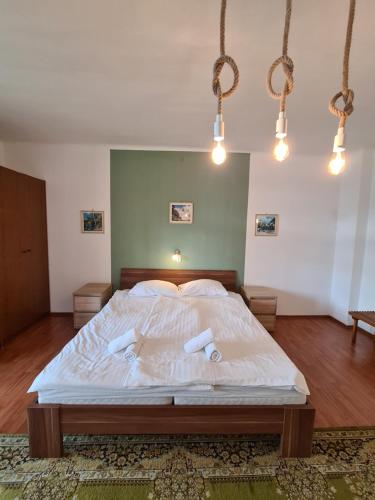 a bedroom with a bed with two towels on it at Vila Gorenka in Bled