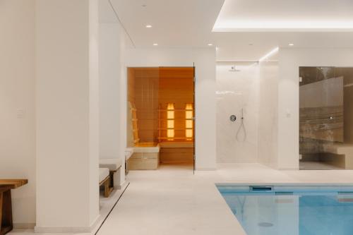 a bathroom with a swimming pool next to a shower at Portwin luxury stays in Knokke-Heist