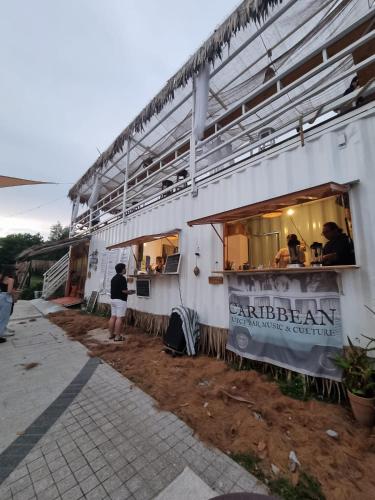 a person standing in front of a food truck at Teega Residence @ Cosy Seafront Living in Nusajaya